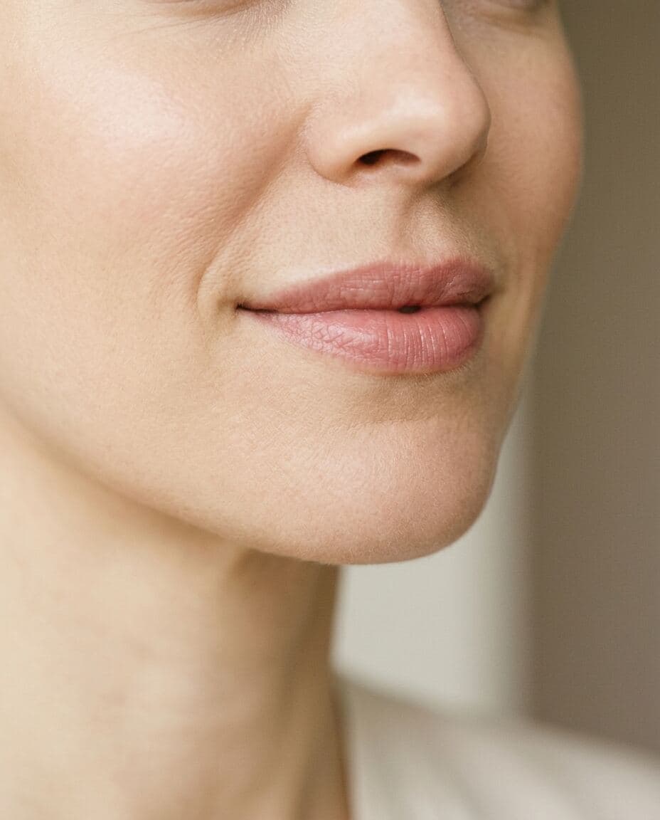 Close-up of a woman's softly smiling lips showing the subtle fuller upper lip of a Botox lip flip at The Beauty Spot Medspa in North Haven, CT.